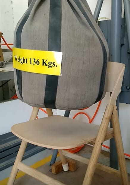 A chair is being weight tested with a 136kgs bag