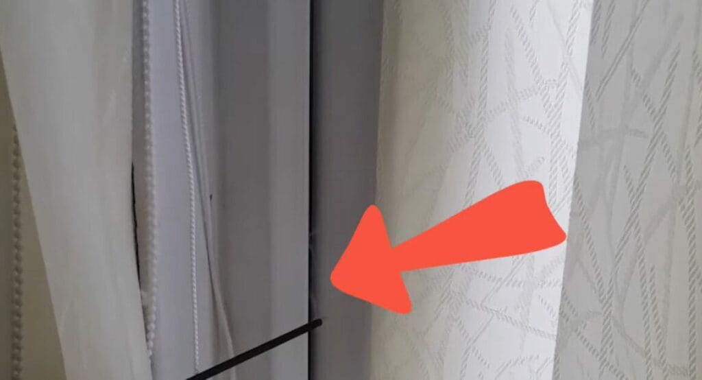 An affordable curtain with a red arrow pointing to it
