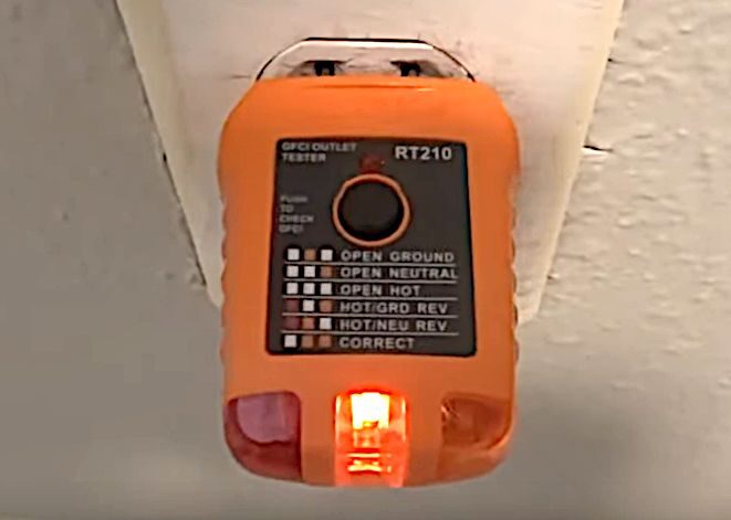 An outlet tester showing no ground indication on an outlet