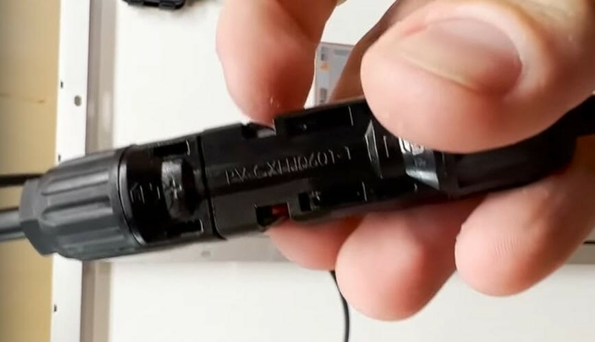 A person inserting the male connector of one into the female connector