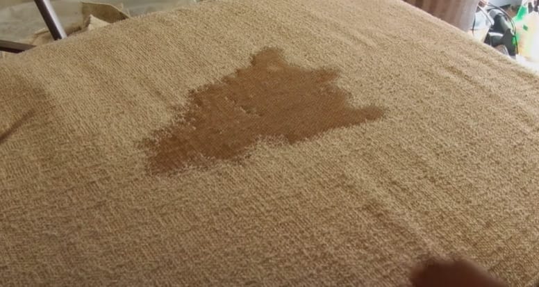 A spilled liquid on a brown upholstery