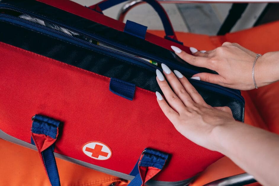 A woman zipping up the emergency bag
