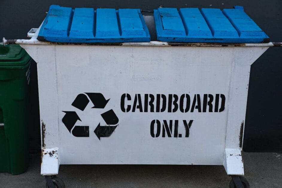 A recycled wooden bin that has a label "CARDBOARD ONLY"