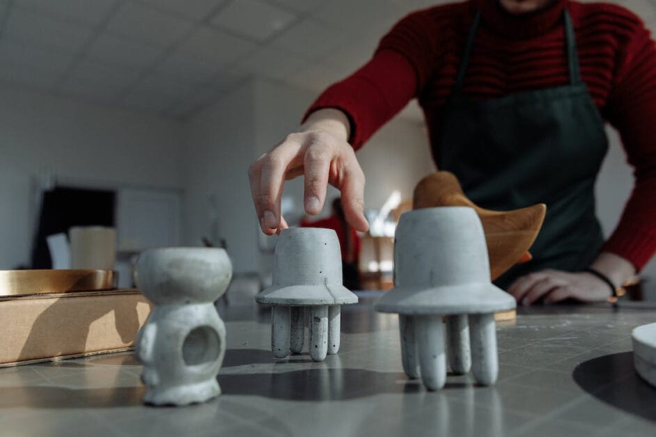 A man putting a pottery items on the table