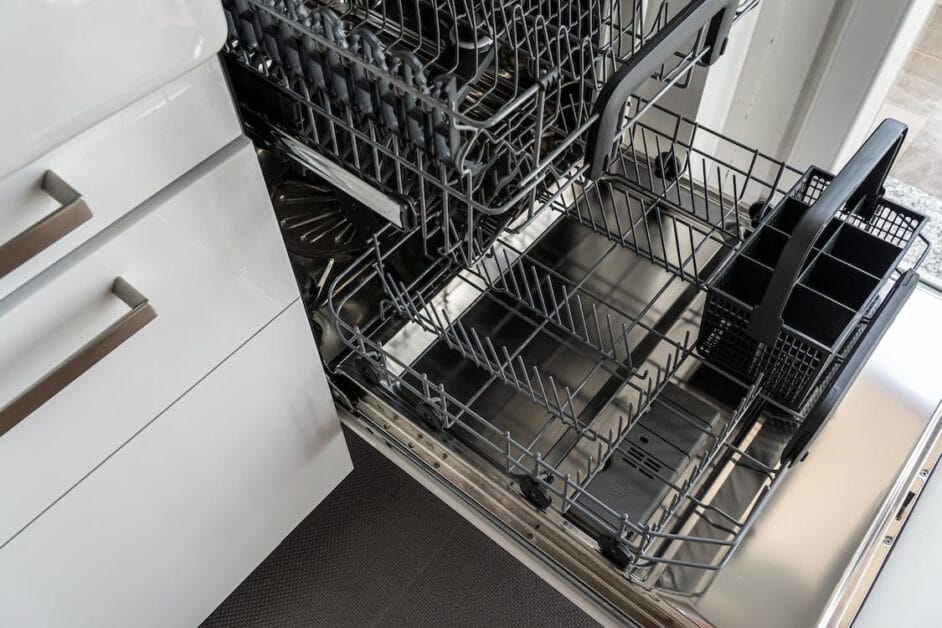 A dishwasher opened at the kitchen cabinet