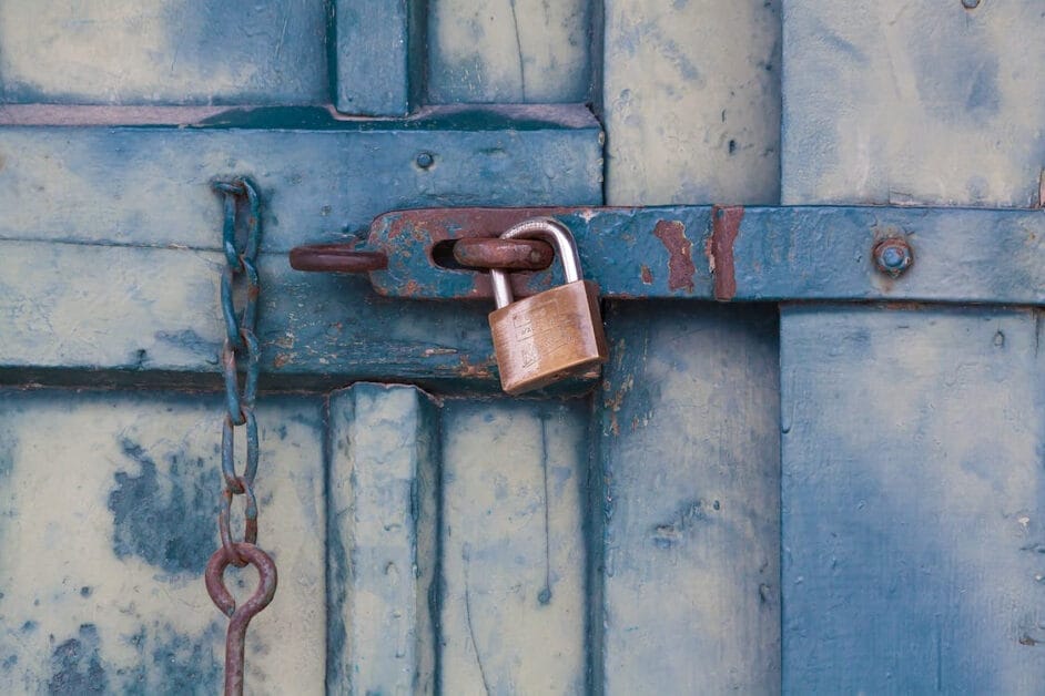 A padlock on a blue wooden door