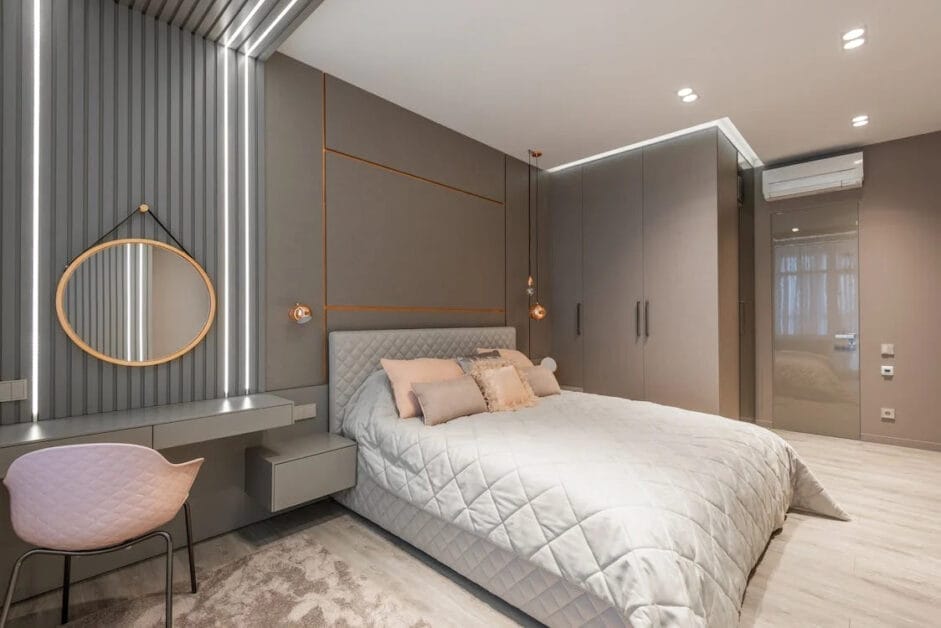 A spotless modern bedroom with grey walls and pink accents