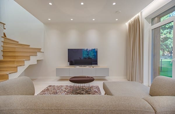 A modern living room with a tv and stairs