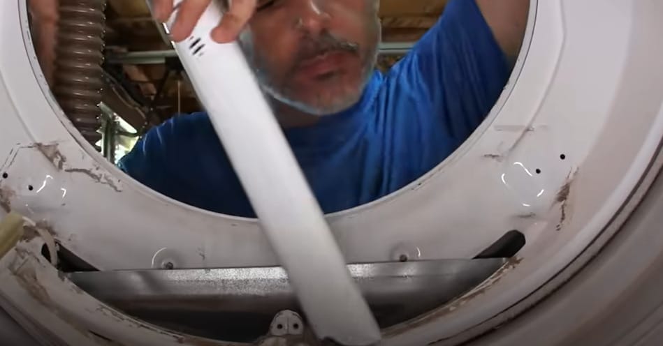 A man disconnecting the vent tubing of a dryer