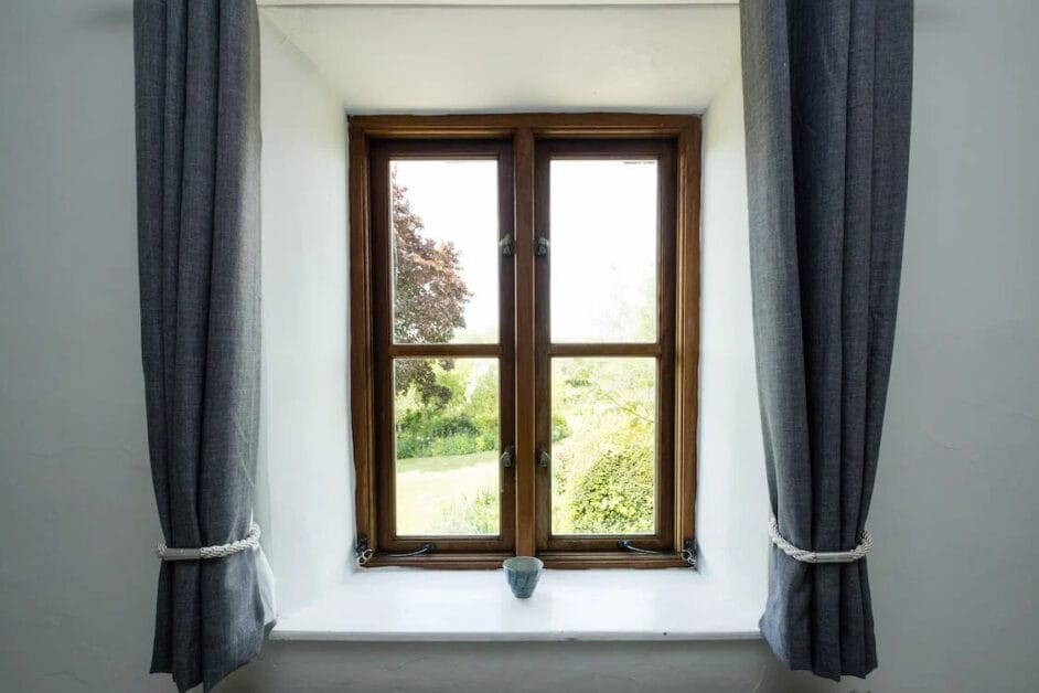 A big window with curtain on both sides
