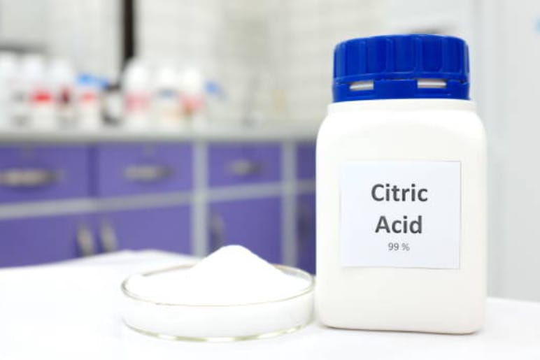 A bottle of citric acid sitting on a table