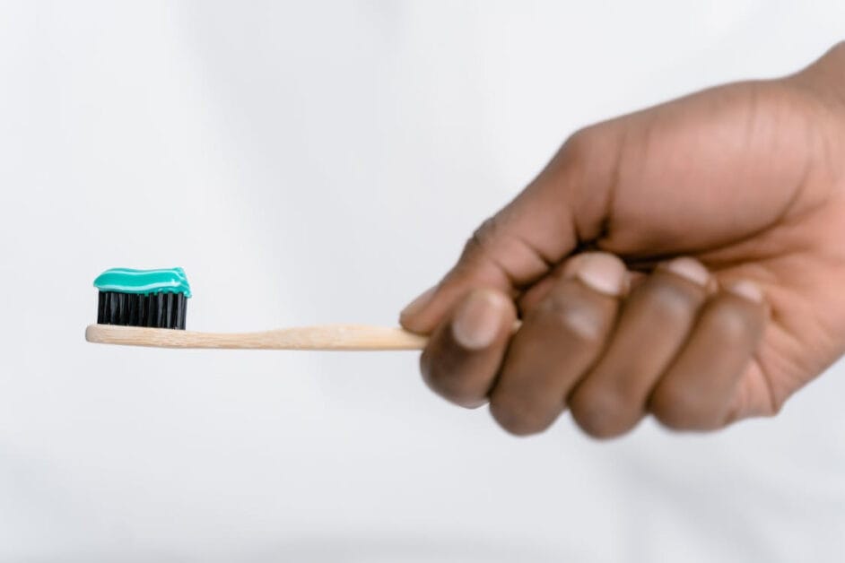A man holding a toothbrush with toothpaste in it