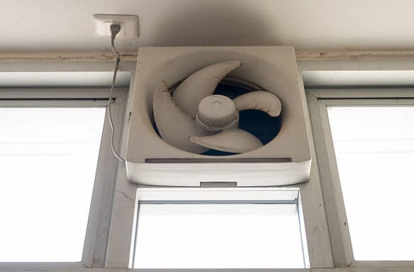 An exhaust fan installed at the top section of the room