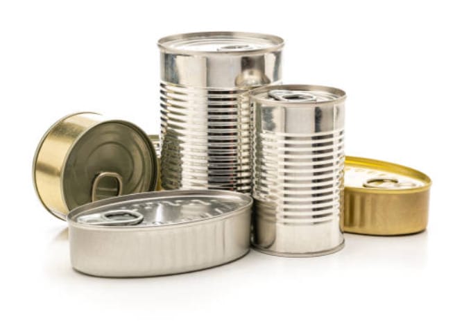 A group of unlabeled tin cans on a white background