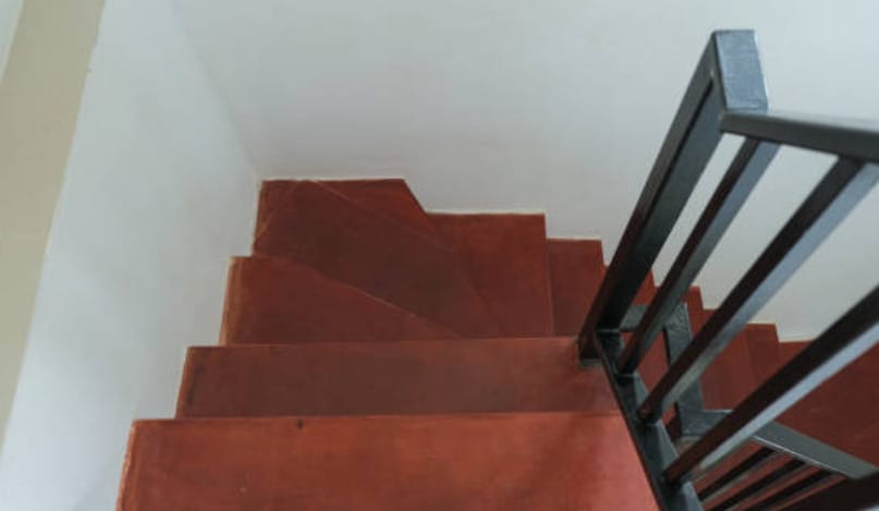A house stairs with wooden step and iron steel railings
