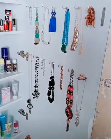 A clever closet organization hacks for a jewelry hanging on the closet wall