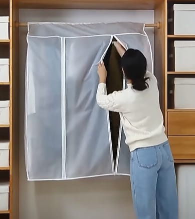 A woman is opening a protective covered garment organizer