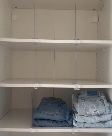 A white closet showcasing a organizing hack for jeans