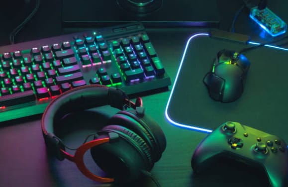 A gaming mouse, keyboard, and headphones are on a desk