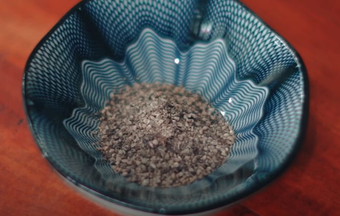 A ground black pepper on a blue printed bowl