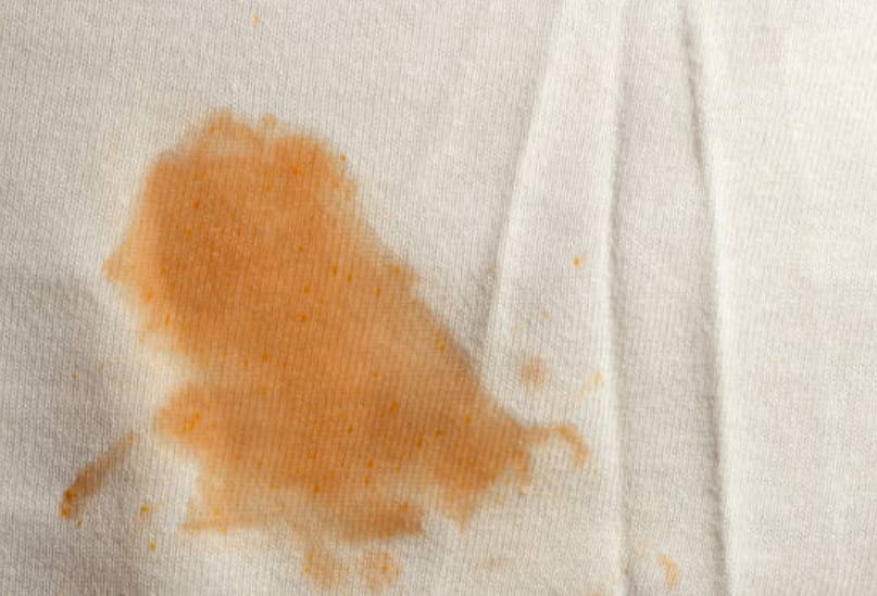 An orange stain on a white clothe