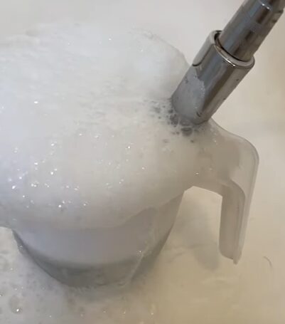 A bubble mixture of baking soda and distilled water paste to clean a metal