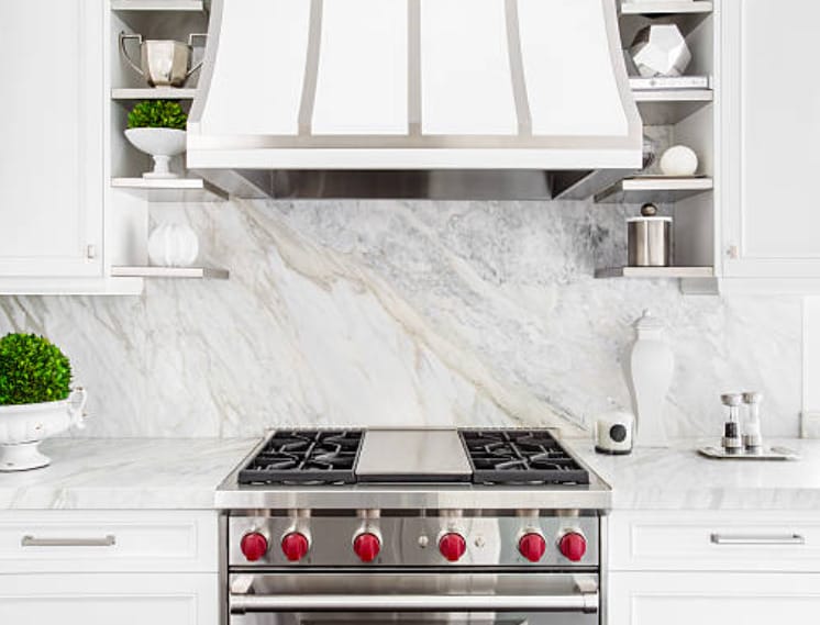 A white kitchen with a stove and oven