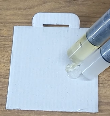 Putting the epoxy mixture on a syringe and put a portion of the mixture into a piece of white card