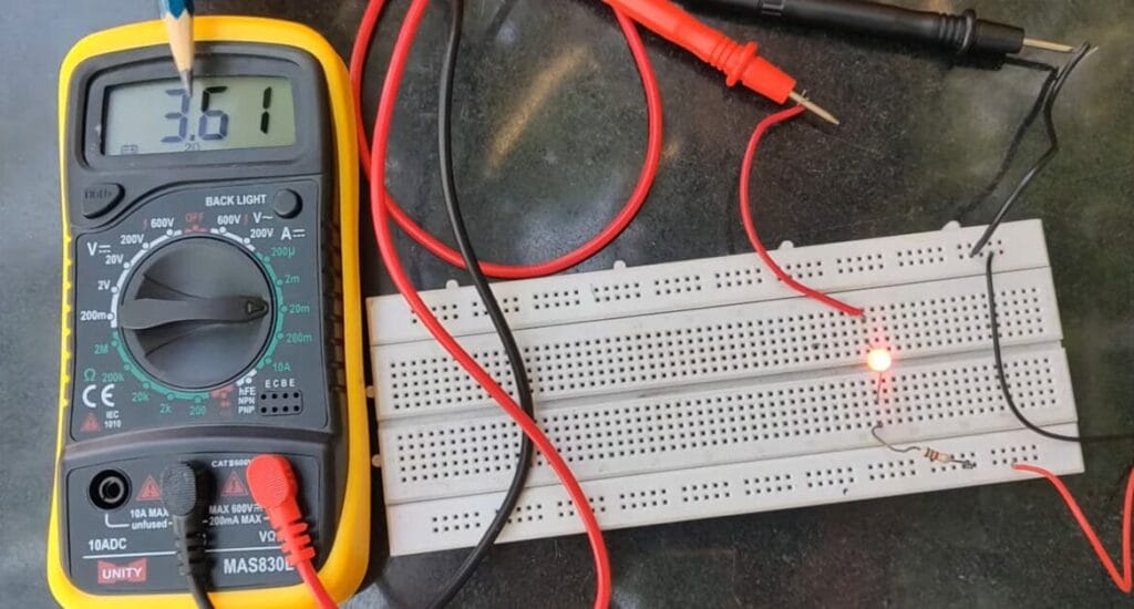 A circuit board is being tested by a multimeter