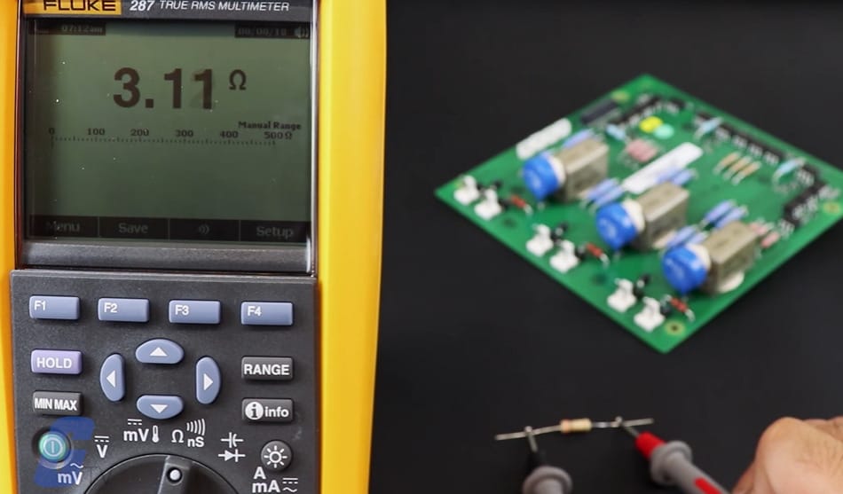 A Fluke TRUE RMS multimeter with a reading of 3.11 on the screen
