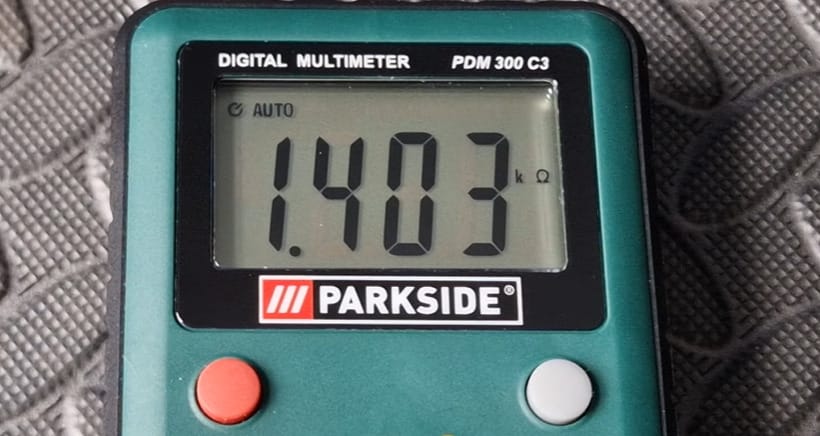 A PARKSIDE green digital multimeter showing a 1.403 reading on the screen