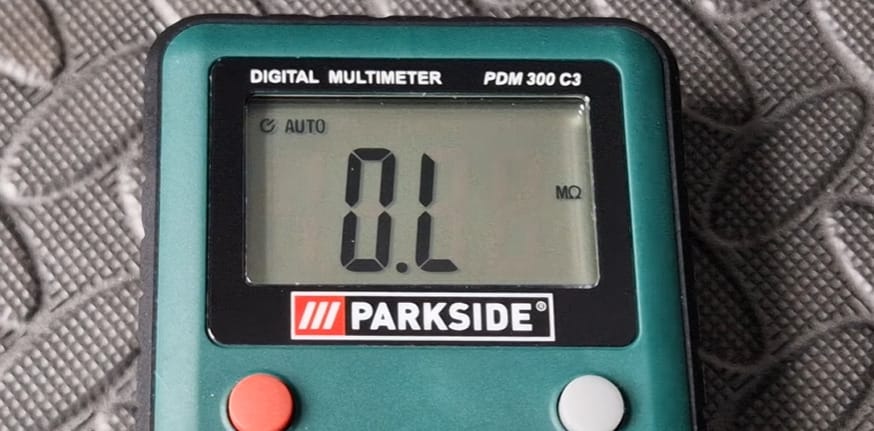 A PARKSIDE green digital multimeter showing a OL reading on the screen