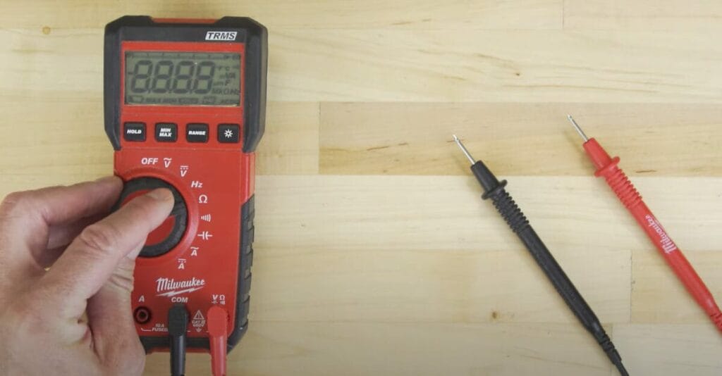 A person is setting up the Milwaukee digital multimeter