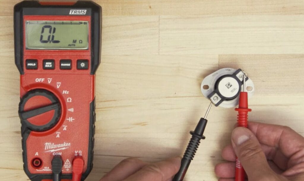 Milwaukee multimeter is being used to check continuity of a battery