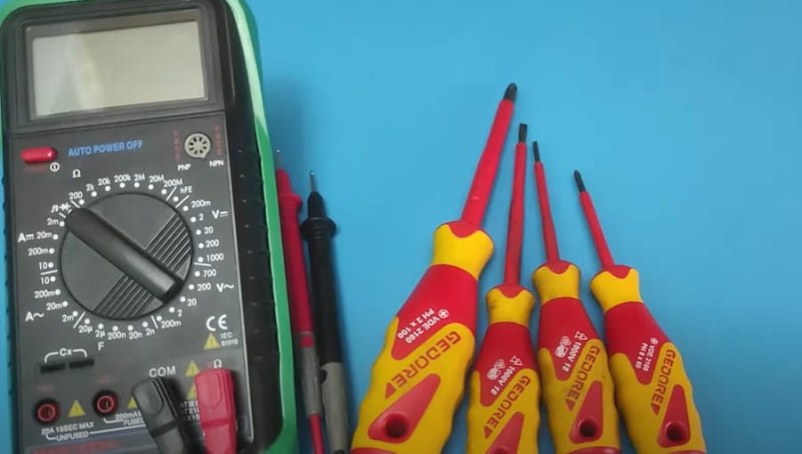 Multimeter set and screws on a blue background