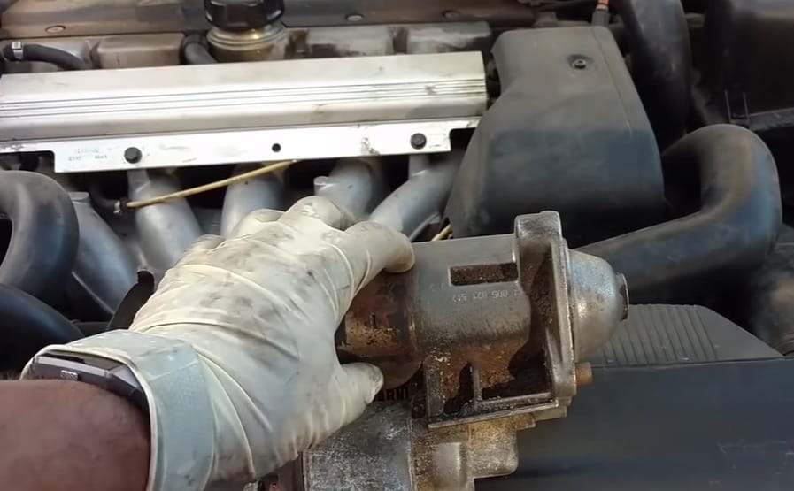 A person is troubleshooting a car's engine