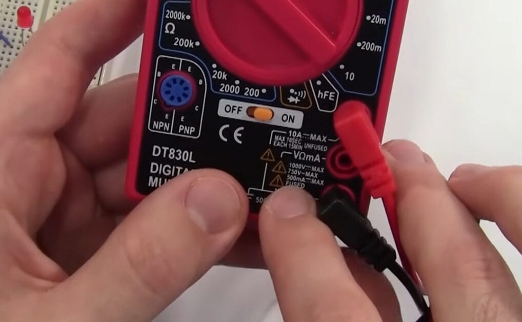 A person holding a multimeter set