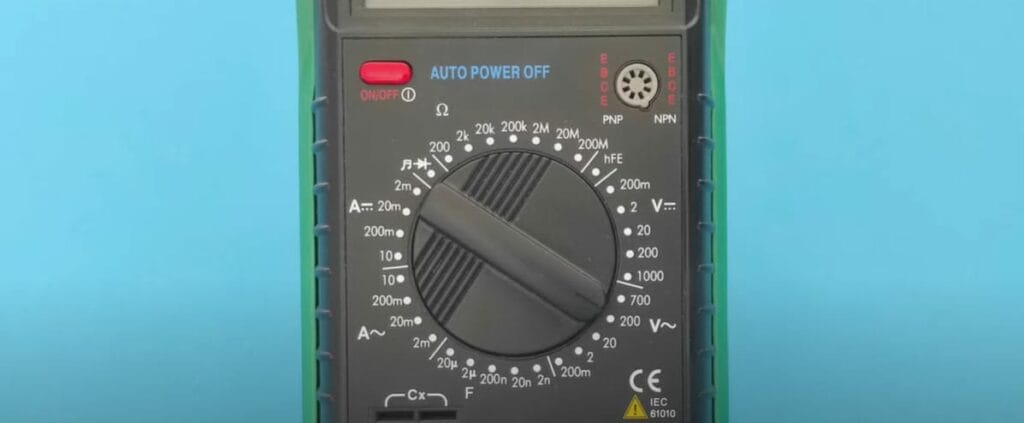 A digital multimeter displaying voltage readings on a blue background