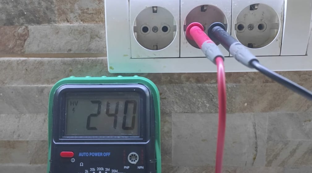 A multimeter is used to check an outlet