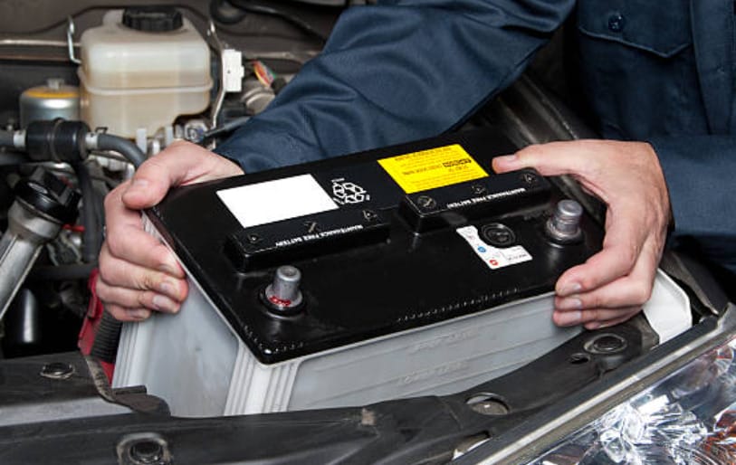 A man working on a car battery