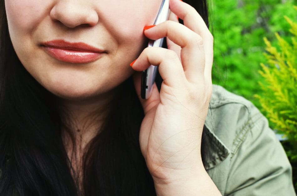 A close up shot of a woman answering a phone