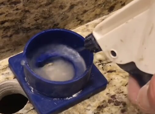 A person is cutting the second hole using a wet method
