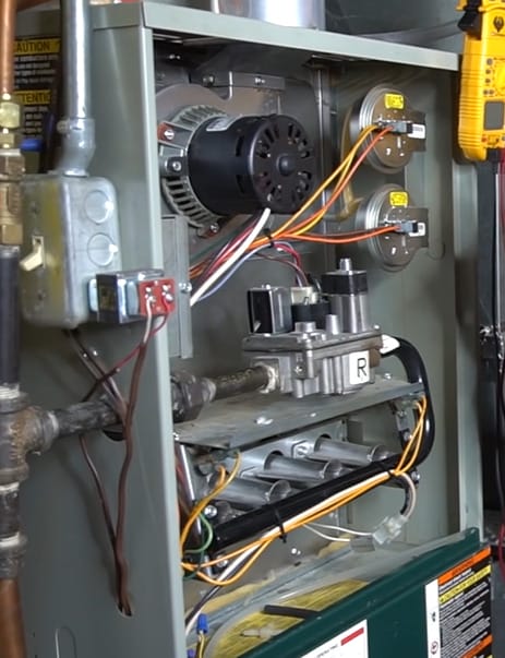 A gas furnace with wires attached to it