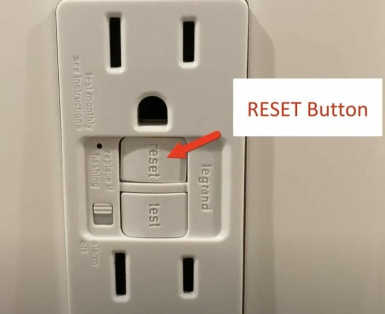 A white outlet with a reset button, indicating how to determine if a GFCI outlet is faulty
