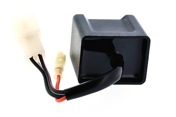 A black box with wires attached to it, commonly known as a CDI box.