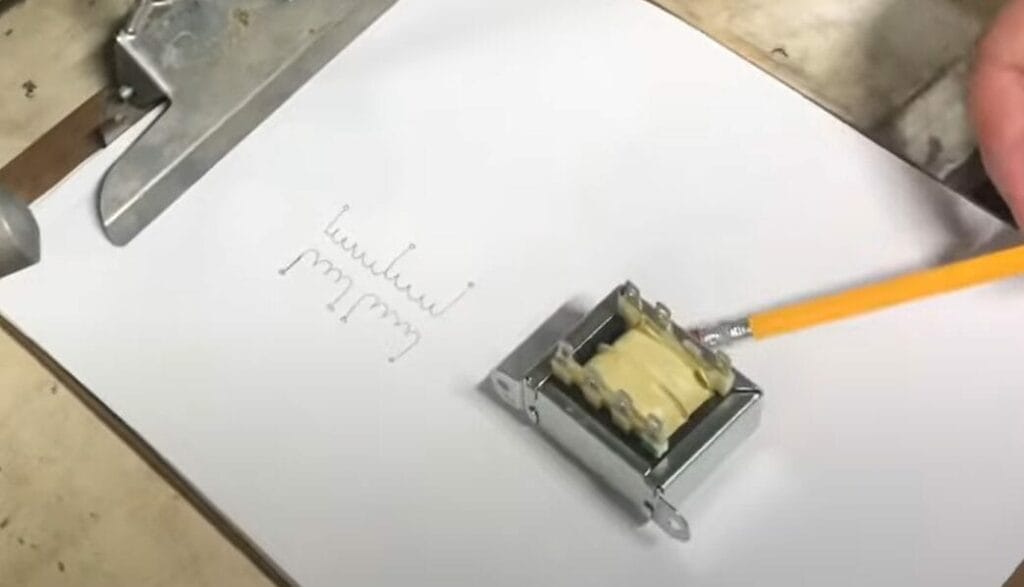 A person is using a pencil to draw on a piece of paper