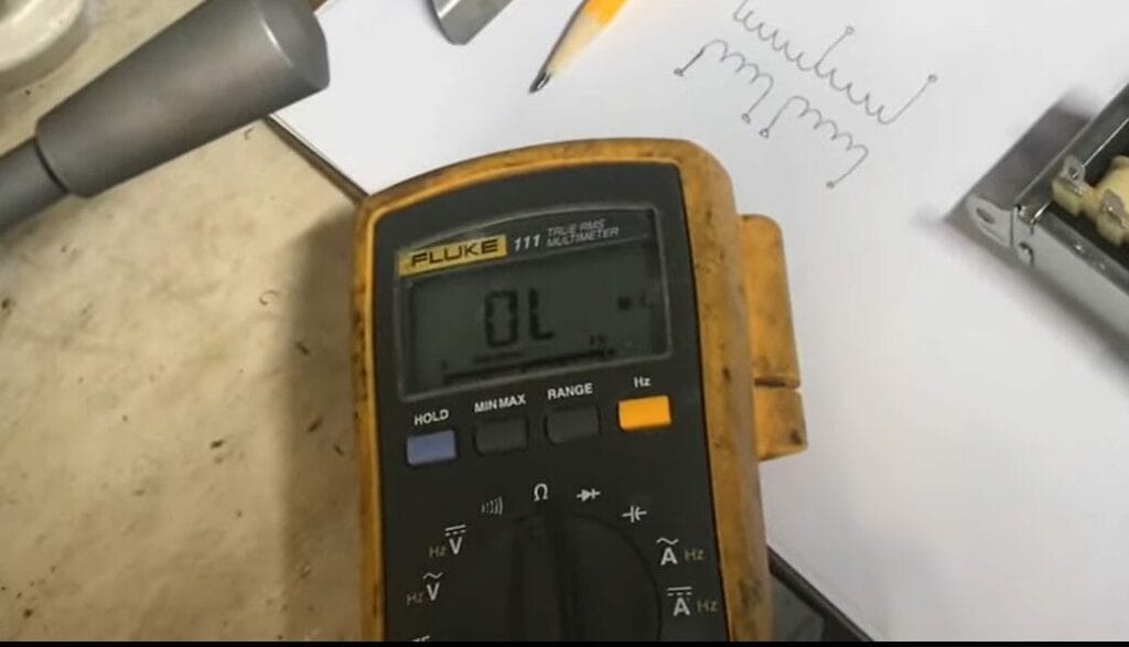 A multimeter is sitting on top of a piece of paper