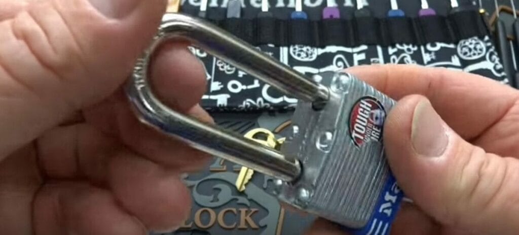 A person is holding a padlock