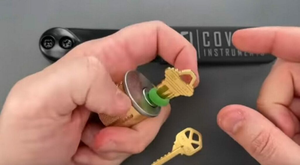 A person is inserting a key into a lock
