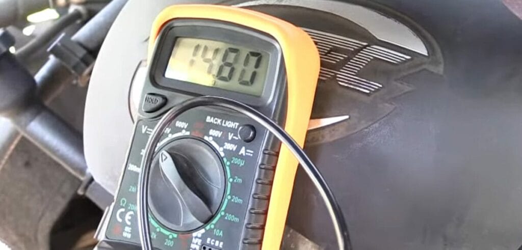 A multimeter is attached to the engine of a motorcycle to determine whether a bad alternator can ruin a battery